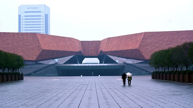 Two people walk in the center of Wuhan, the epicenter of the COVID-19 outbreak